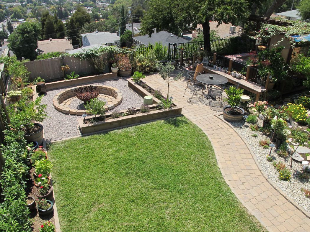 fire pit with patio, planters seating and garden path