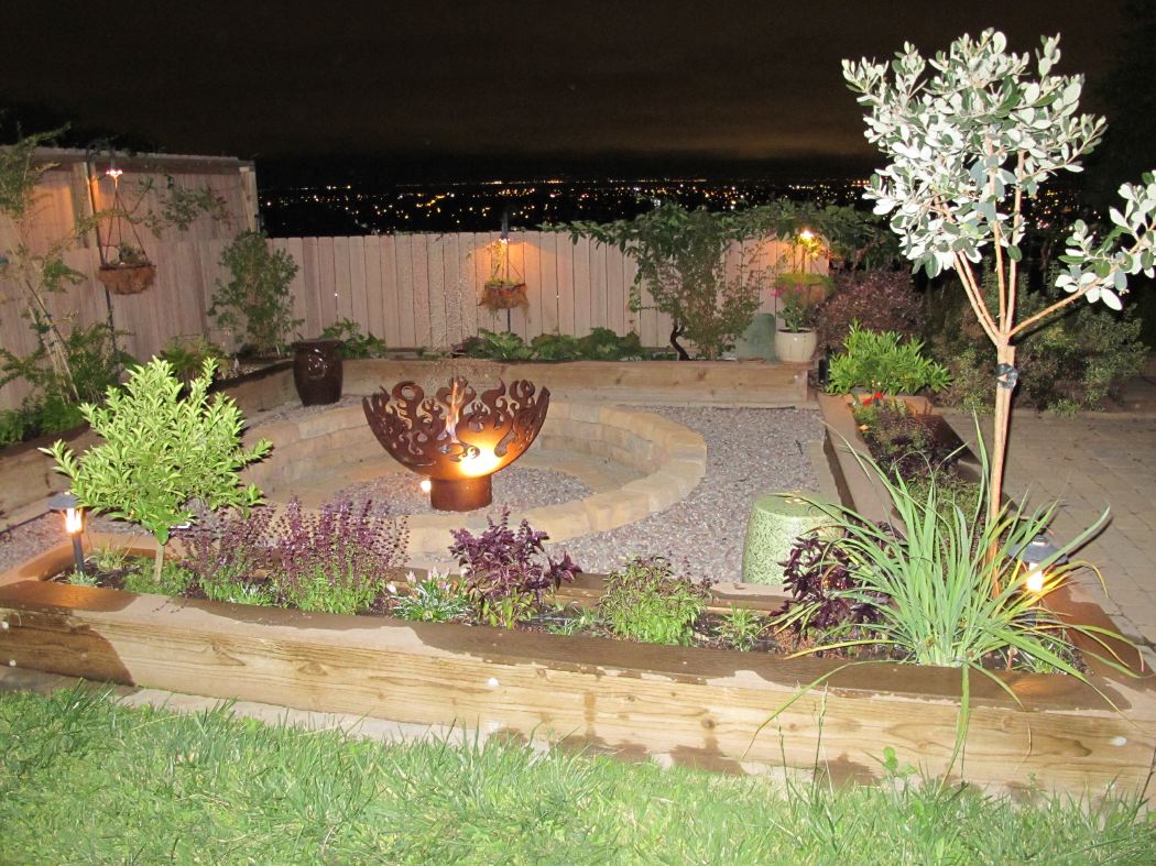 Fire Sculptural Fire Pit round stone and gravel patio