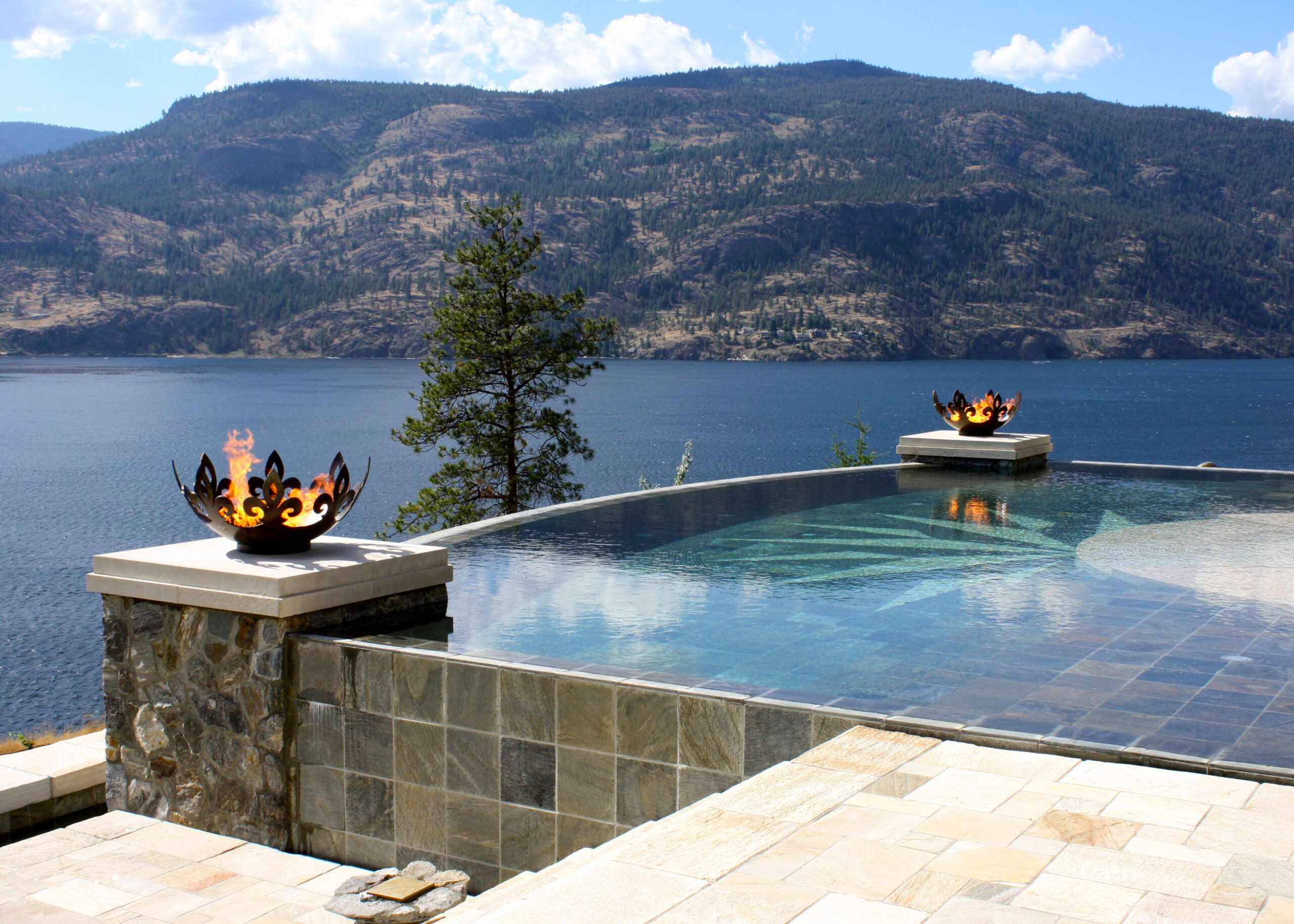 Fiery Fleur-de-lis 37 Inch Sculptural Fire pits Flanking Infinity Pool Over Lake Okanagan