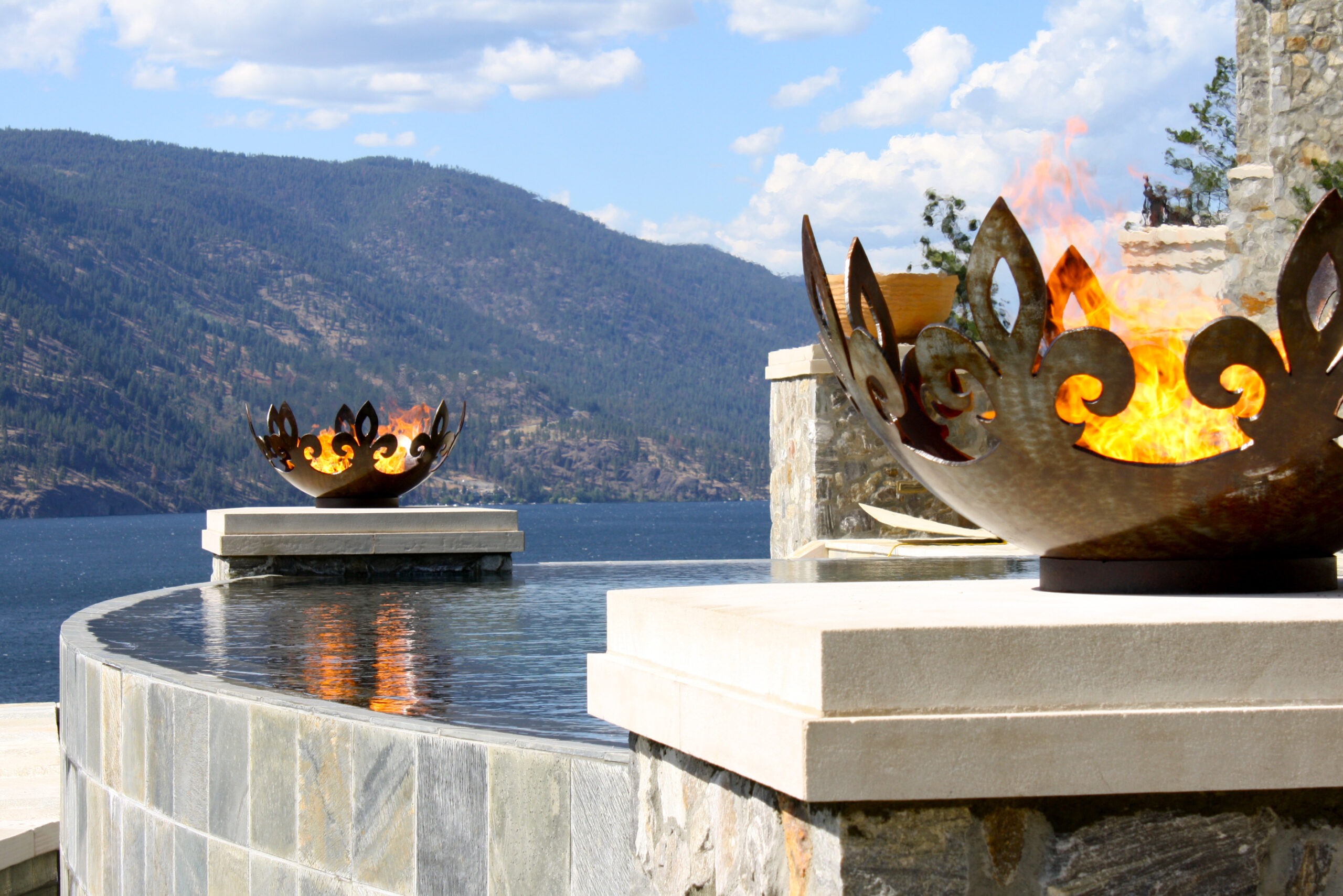 Fiery Fleur-de-lis 37 Inch Sculptural Fire Pit Flanking Infinity Pool Over Lake Okanagan