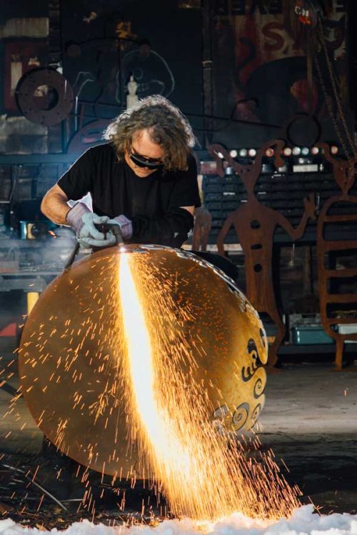 Rachael Que Vargas cutting a Hudson Valley Fire Pit